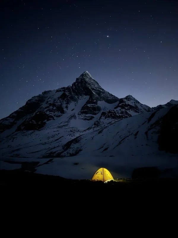 Trekking · a lit tent under the stars, a snow peak behind it